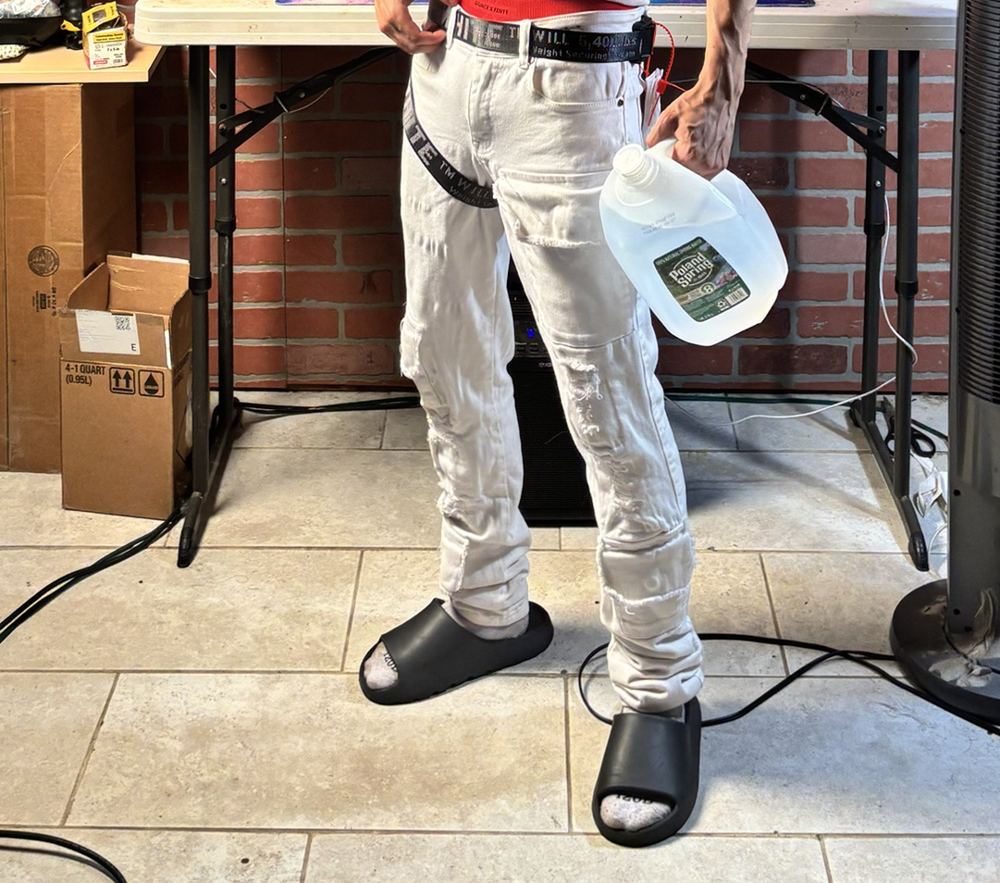 White outfit with a black Off-White belt wrapped around the leg